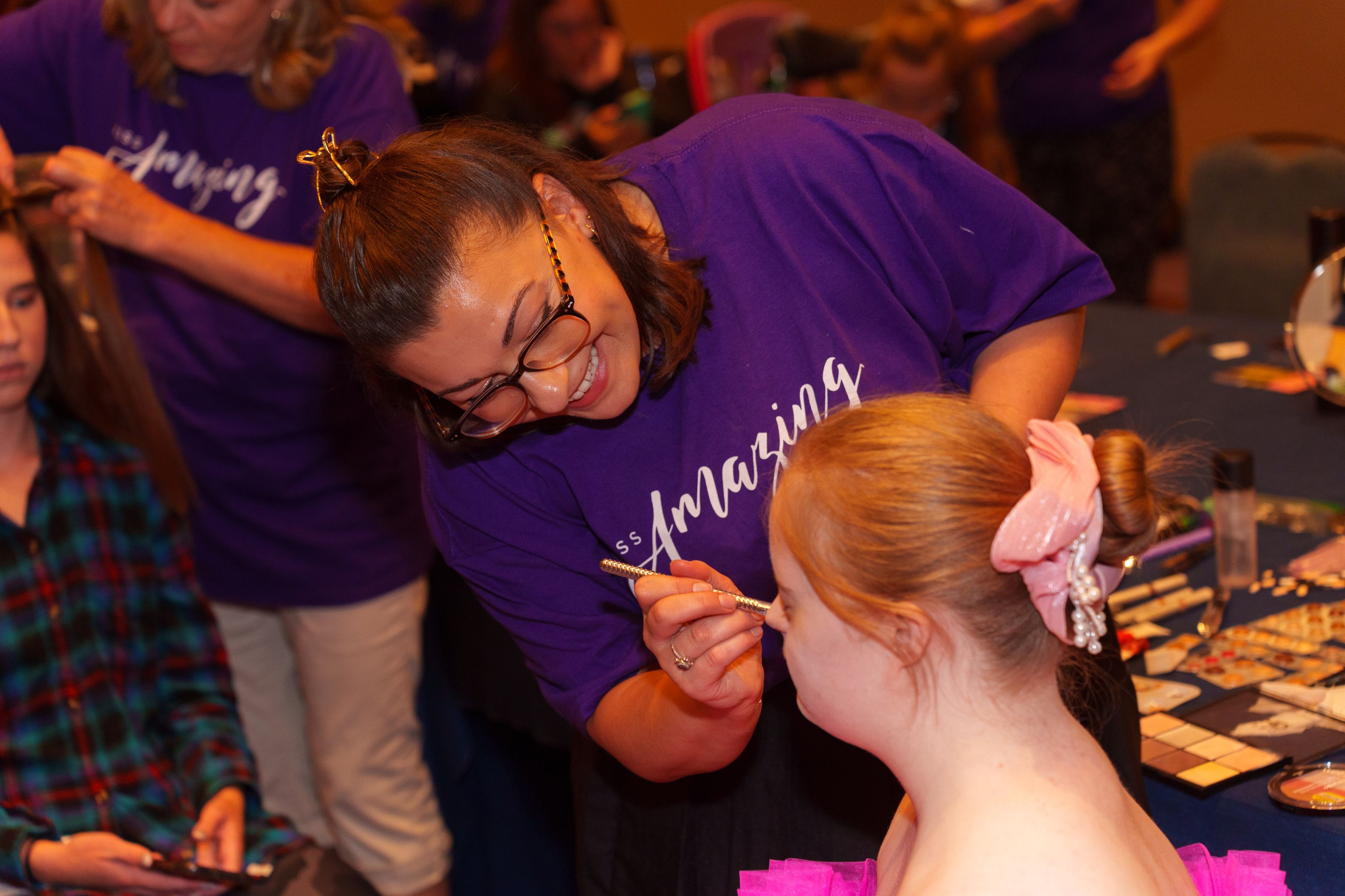 A stylist from La Petite Hair Studio does the makeup for one of the participants at the 2023 Summit.